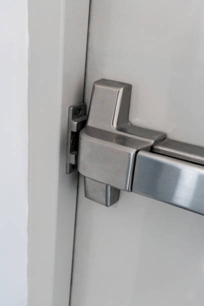 istock Closed up latch and door handle of emergency exit. Push bar and rail for panic exit. 871906138