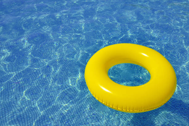 istock Colorful inflatable tube floating in swimming pool 871908068