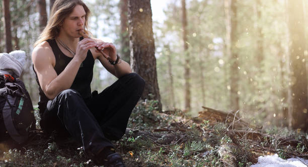 istock A musician with a tool in nature. A man is playing a flute in a 871908952