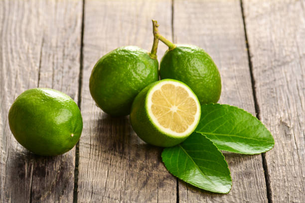 istock Juicy lime on a wooden background 871909154