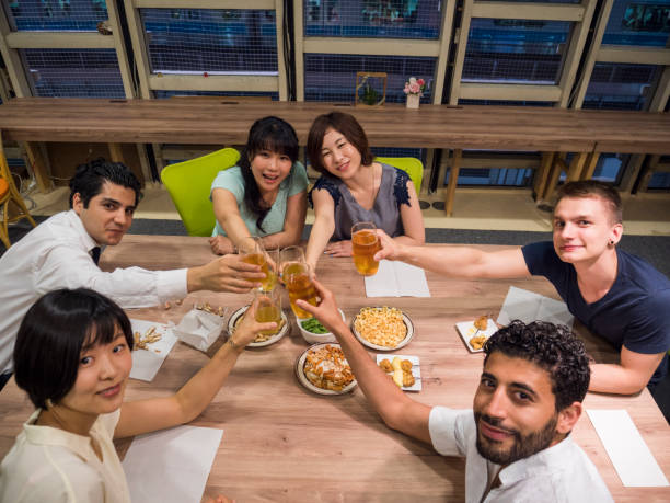 istock International business group drinking beer after work. 871911838