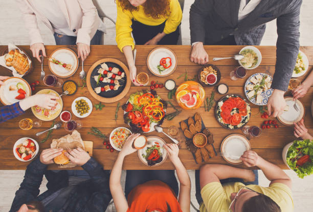 istock People eat healthy meals at served table dinner party 871923378
