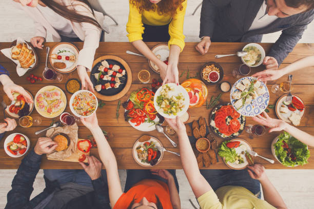 istock People eat healthy meals at served table dinner party 871923460