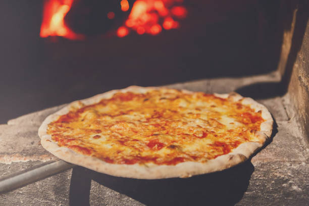 istock Fresh baked pizza with cheese near oven 871928124