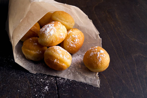 istock round donuts in a paper bag sprinkled with powder 871930666