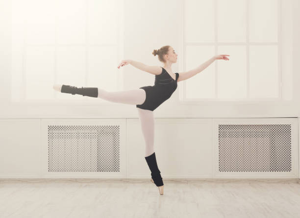 istock Beautiful ballerina stands in ballet arabesque 871930830