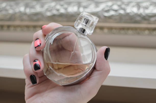 istock Woman hand with perfume bottle . 871930976