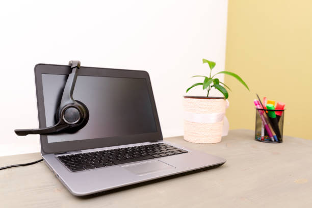 istock headset on laptop computer, concept for communication, it support, call center and customer service help desk 871931414