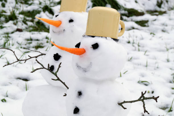 istock Two snowmen handmade in the snow. 871931726