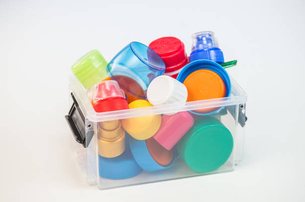 istock Plastic bottle screw caps in box isolated on white 871932236