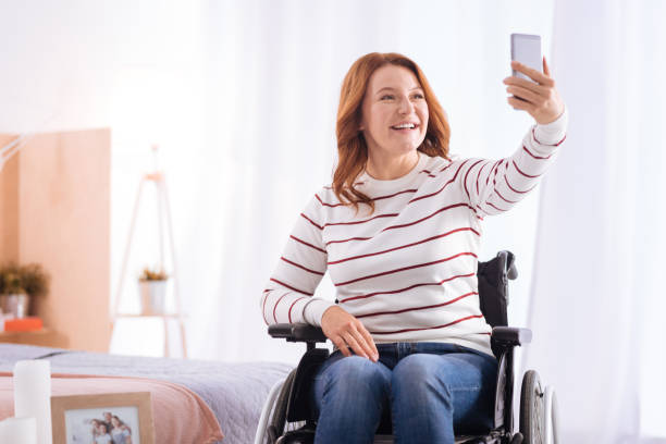 istock Disabled smiling woman taking photos 871932980