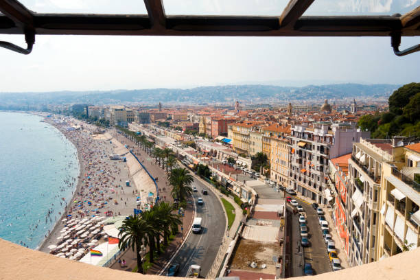 viewpoint overlooking blue mediterranean sea beach with palm trees and bright and colorful city of nice france on sunny day in cote d-azure - overtaken imagens e fotografias de stock
