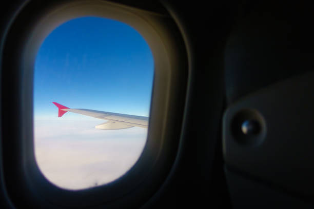istock Wing of the plane can be seen through window 871935322