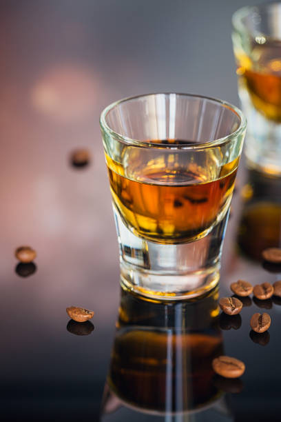 istock Cognac or liqueur, coffee beans and spices on a glass table. 871936042