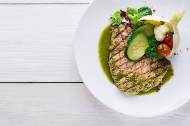 istock Grilled beefsteak with vegetables and green bell pepper sauce 871936048