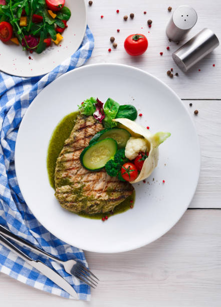 istock Grilled beefsteak with vegetables and green bell pepper sauce 871936114