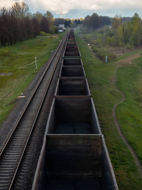 istock Fly view of railway tracks and empty freight train 871936400