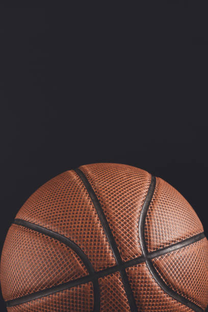 istock Old basketball ball on black background copy space 871940206