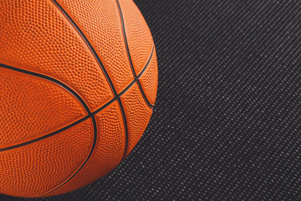 istock Basketball ball on black background copy space 871940376