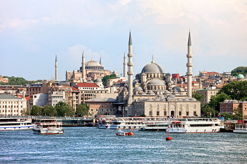 Historic Eminonu district in city of Istanbul, Turkey with New Mosque and Hagia Sophia at the farther end.