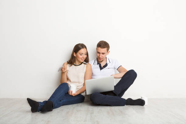 istock Young couple web surfing on laptop 871943688