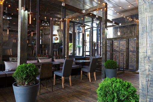 Interior of cozy restaurant. Contemporary design in loft style, modern dining place and bar counter, copy space