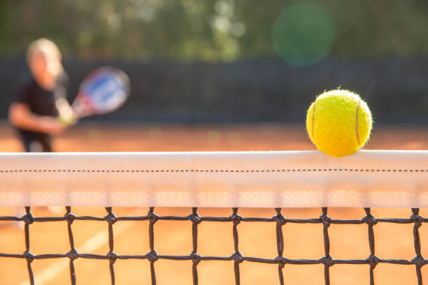 istock Tennis Ball on the Net 871944080