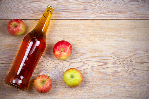 Apple and pear cider on  rustic wooden background. View from above, top, horizontal