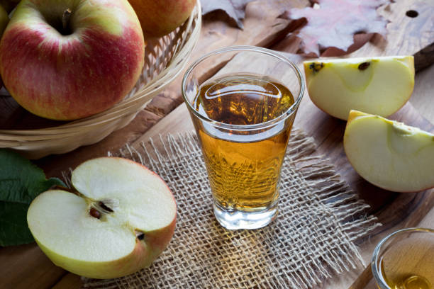 istock Apple cider vinegar in a glass on a wooden table 871946680