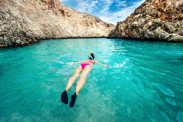 Young woman snorkeling in tropical water. Traveling, active lifestyle concept. Watersports on vacation