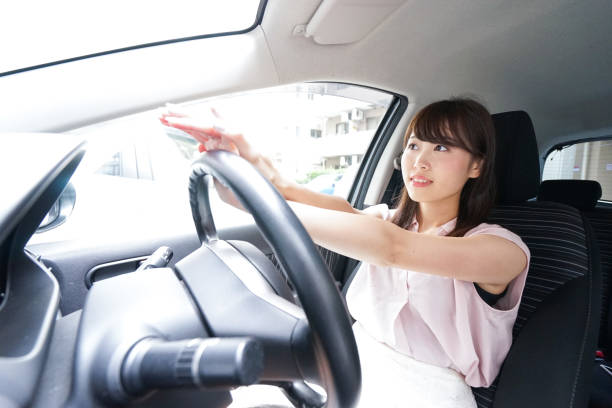 istock Young woman driving car 871951526