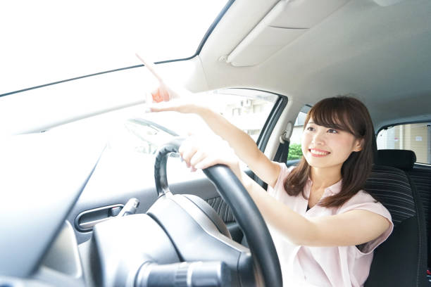 istock Young woman driving car 871951548