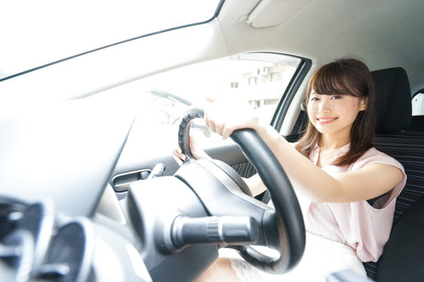 istock Young woman driving car 871951566