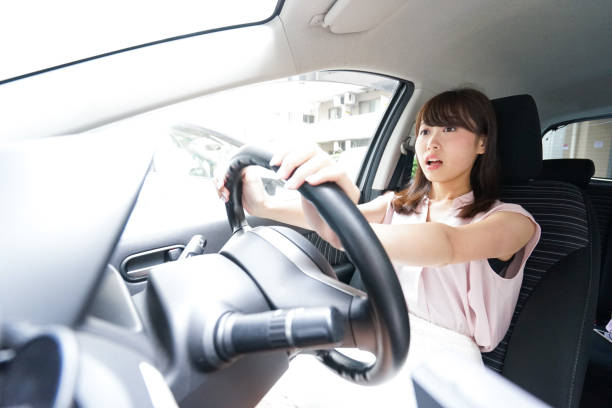 istock Young woman driving car 871951762