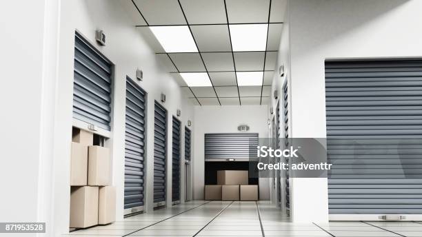 Open Self Storage Units Full Of Cardboard Boxes Among Closed Doors Stock Photo - Download Image Now