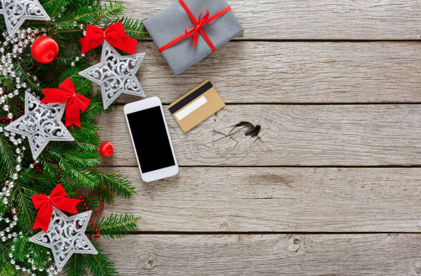 istock Gift box on wood background with phone and credit card 871958426