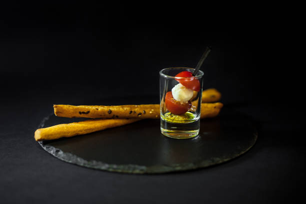 istock Cup with tomato and mozzarella cheese on a black slate 871967136