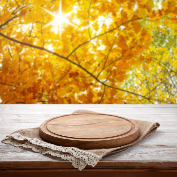 istock Pizza board with tablecloth on wooden table and autumn background - can used for display or montage your products 871967170