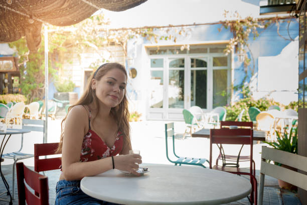 istock Young woman in a sidewalk cafe 871972210