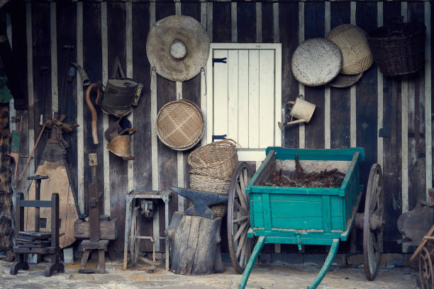 Decorative vintage wooden car wagon and farm objects hanging on the wall. stock photo