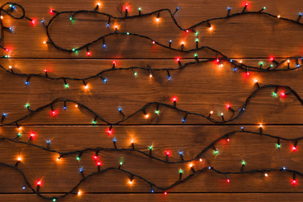 istock Christmas lights on wood background 871976282