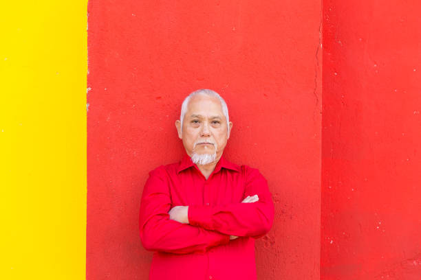 istock Mature asian man on a colorful background 871976504