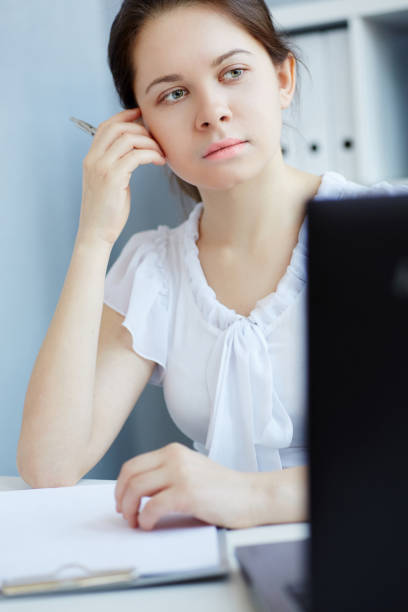 istock Beautiful young student or intern working  on a laptop in the office. 871976876