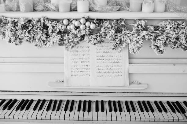 istock White piano with candles. Happy winter holidays concept. 871978276