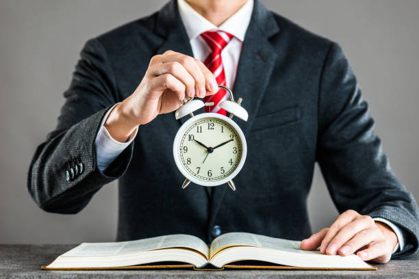 Businessman and alarm clock,studio shooting