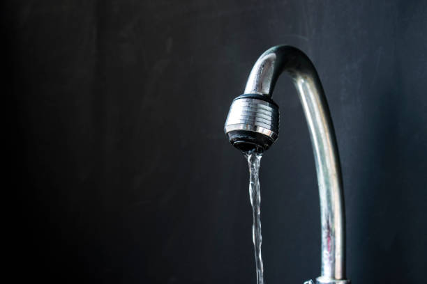 istock water flowing from opened faucet 871983898