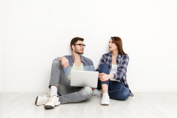 istock Couple discussing work in home interior 871986606