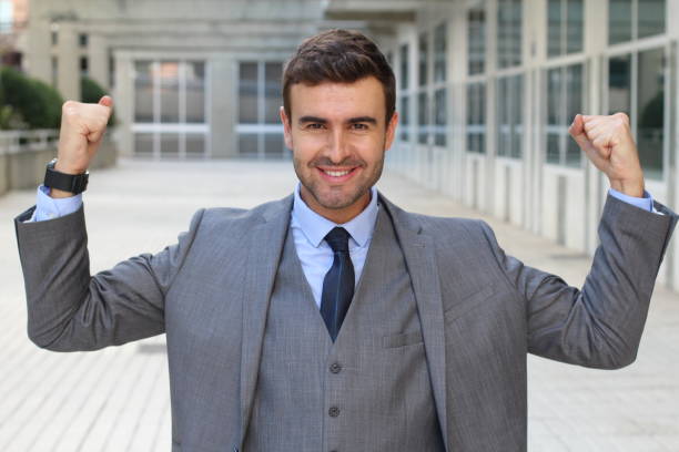istock Elegant funny businessman flexing his muscles 871988716