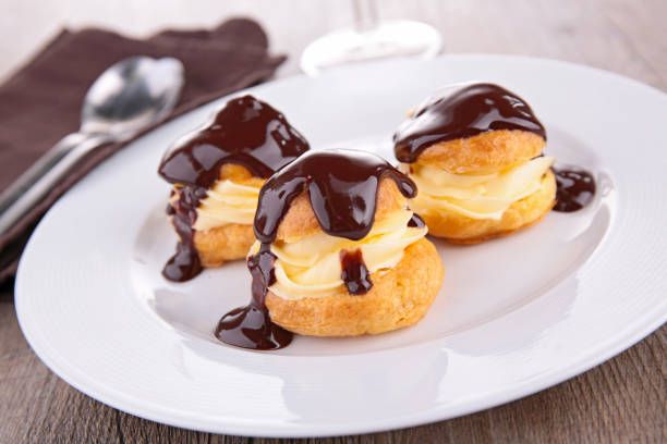 istock profiterole, french puff pastry with cream and chocolate 871990082
