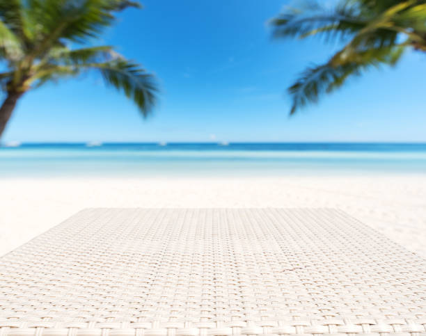 istock Wood weave table surface and tropical beach background 871992642